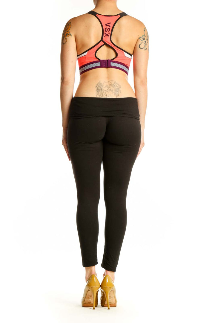 Coral VSX Sport sports bra with black trim, back view showing supportive design