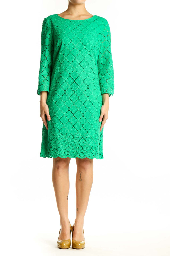 Front view of green eyelet lace A-line dress with three-quarter sleeves and scalloped hem