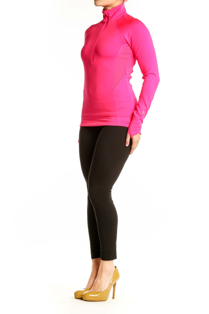 Pink half-zip athletic long sleeve top front view on model