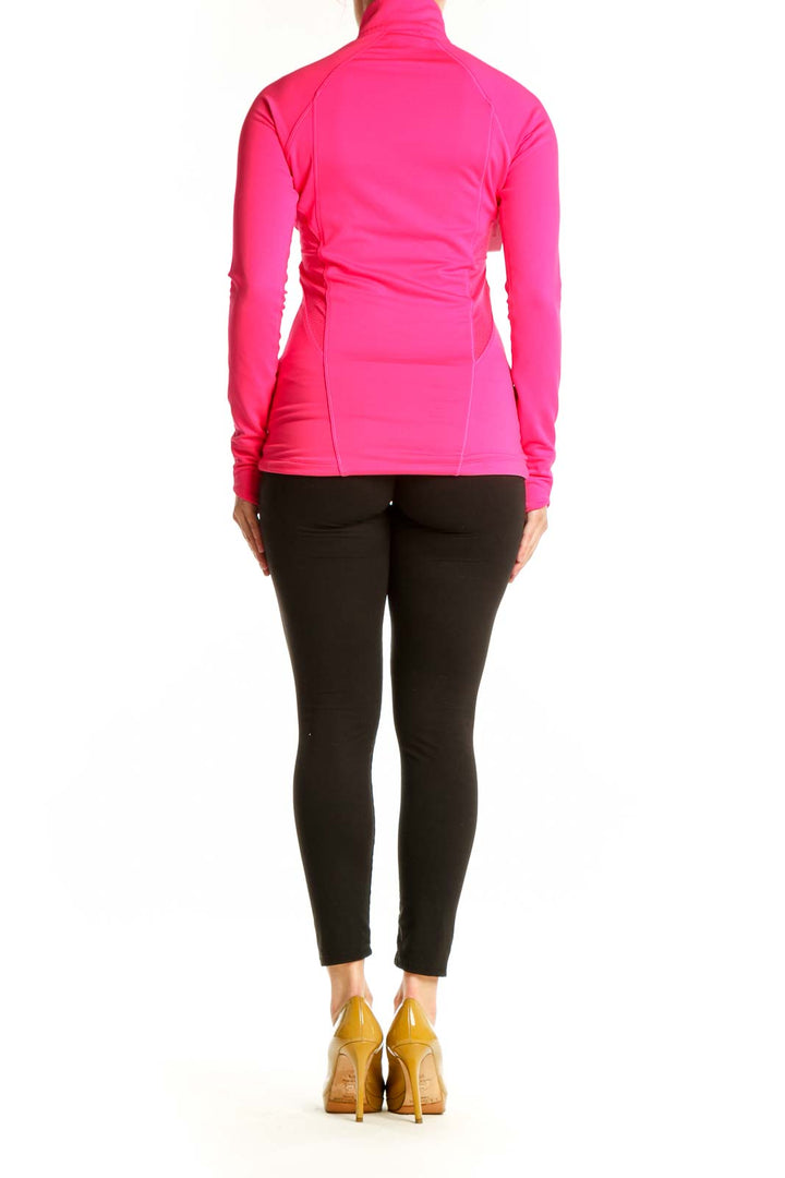 Pink half-zip athletic long sleeve top back view on model