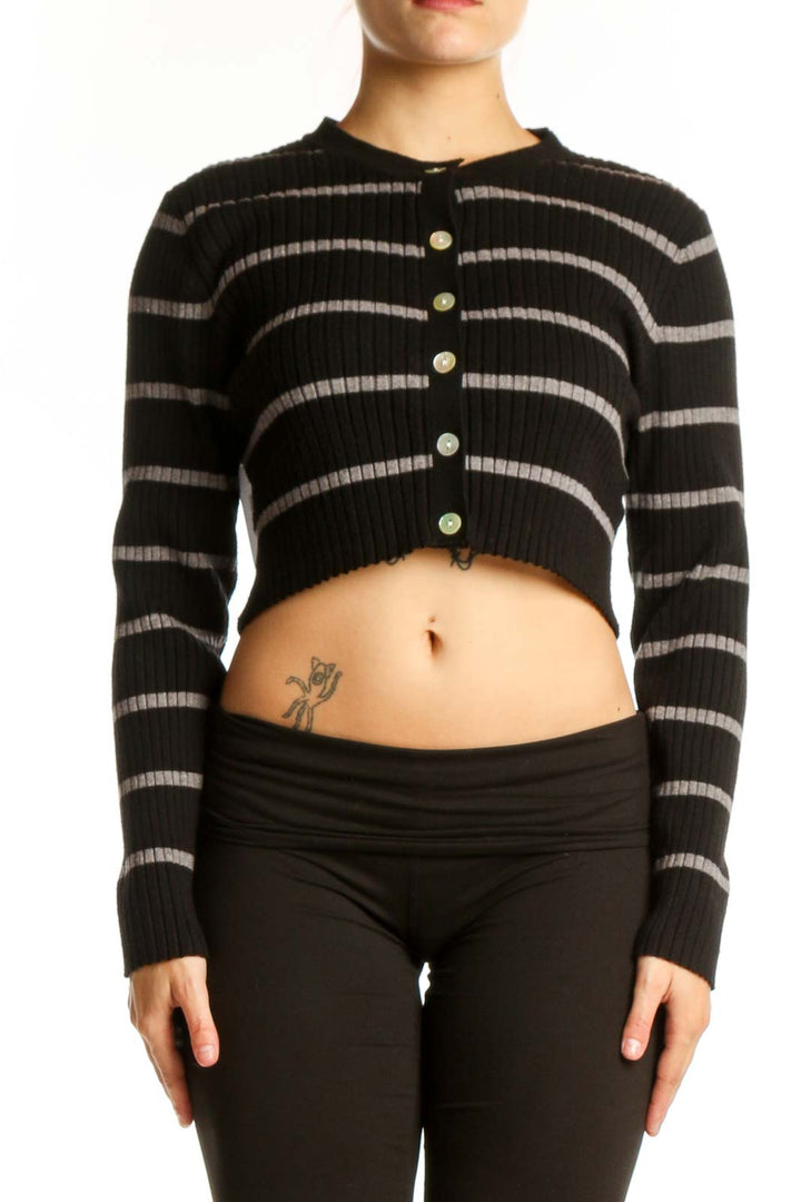 Black and gray striped crop cardigan with button-front closure, worn with black pants