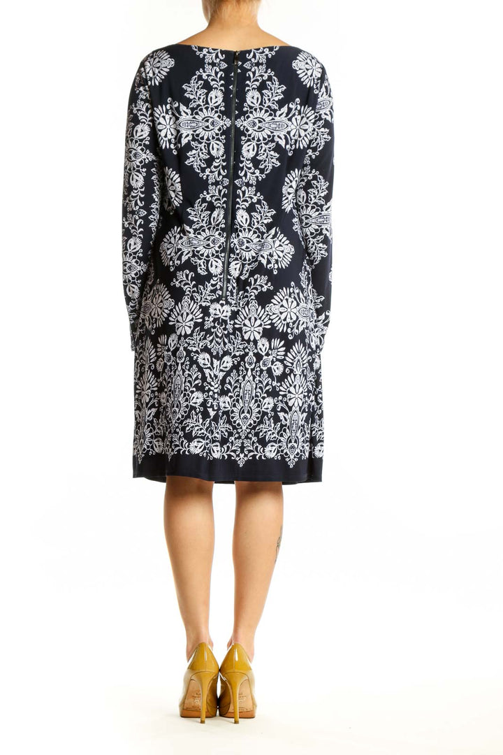Black damask floral long sleeve dress with white ornate print, back view