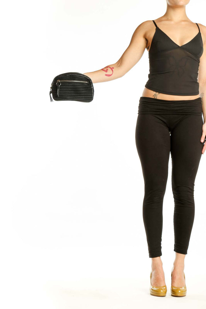 Black studded crossbody bag with zip closure and adjustable strap by Christian Lacroix