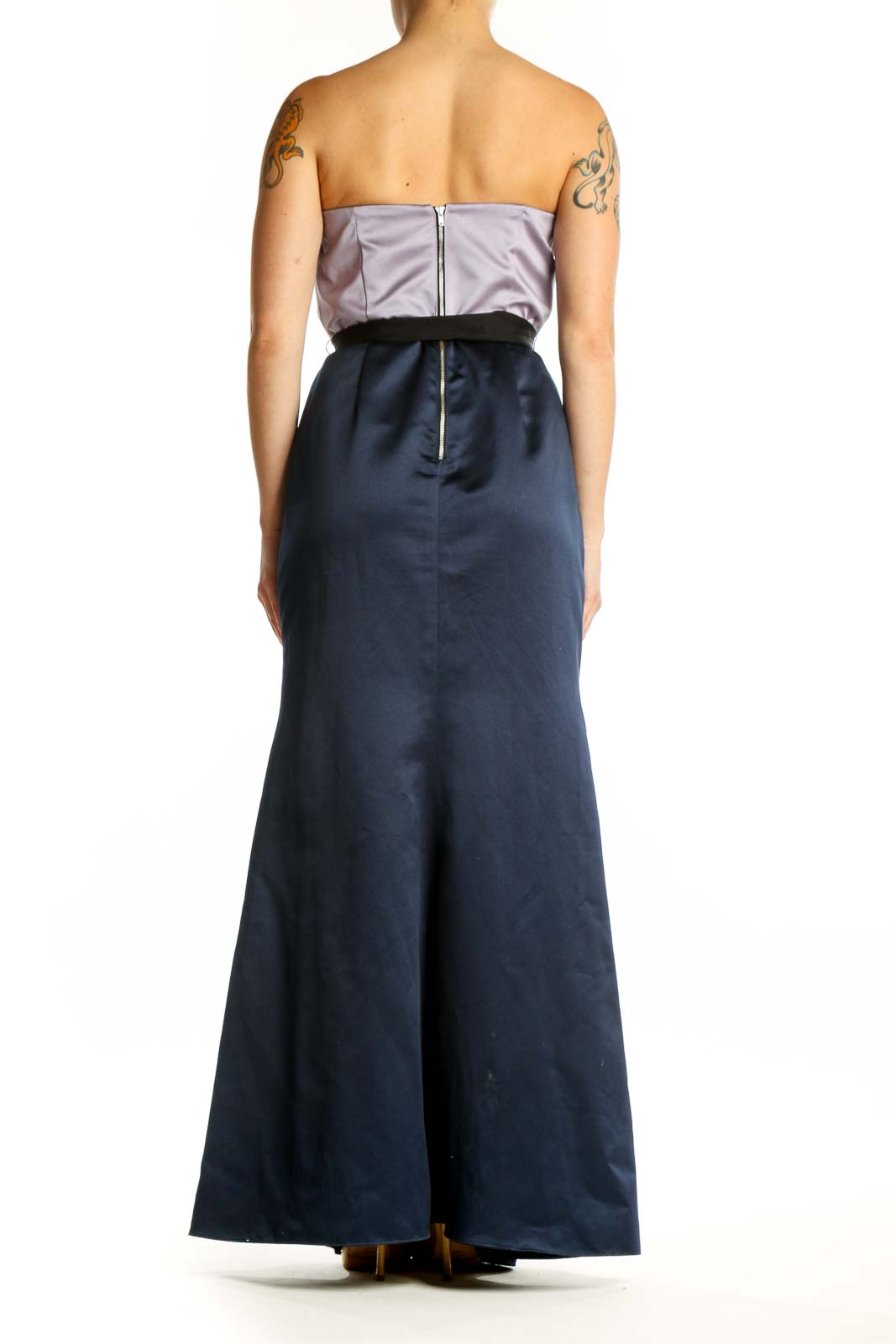 Back view of navy strapless maxi dress showing elegant draping and black bow detail at waist
