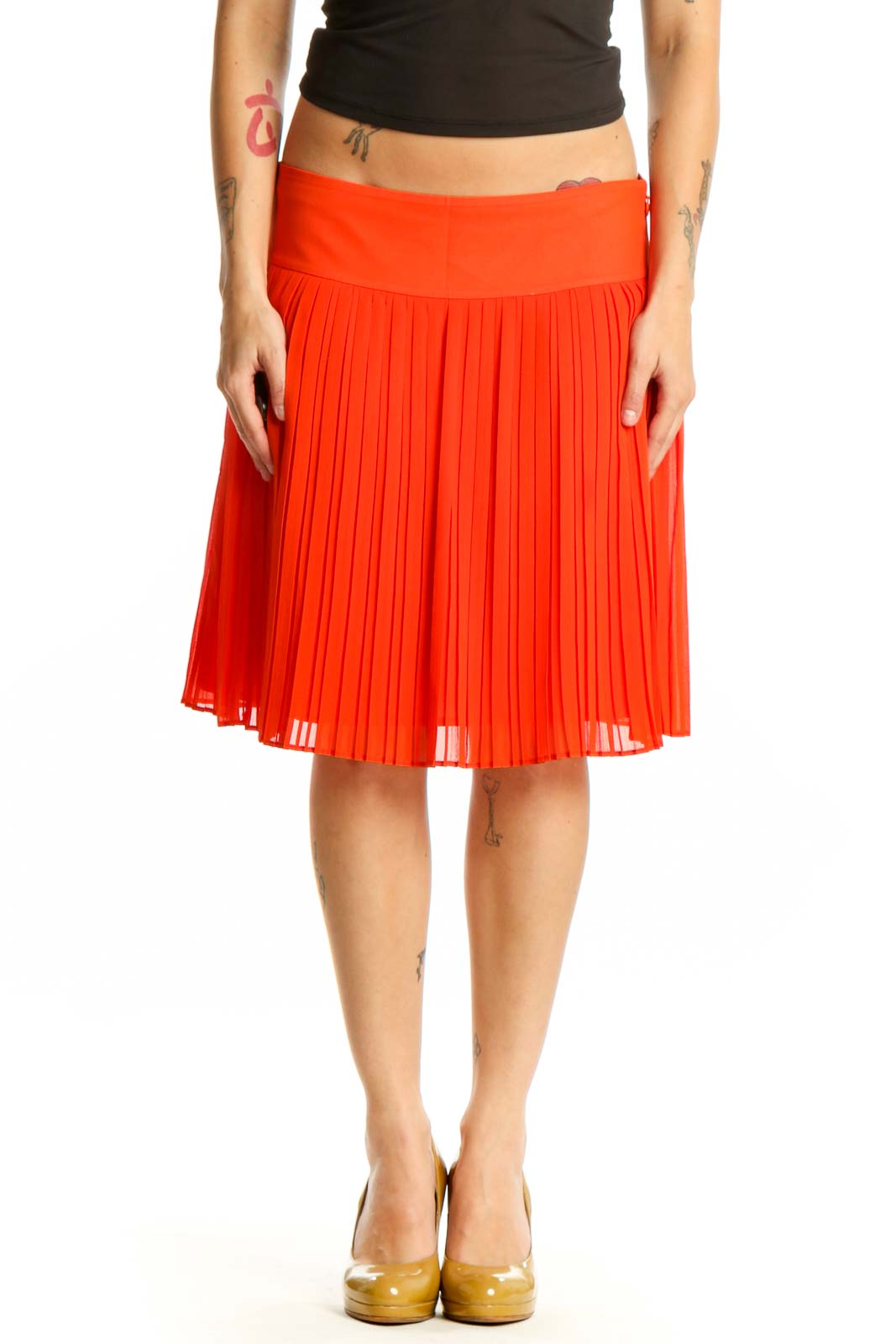 Red pleated A-line knee-length skirt front view on model wearing black top