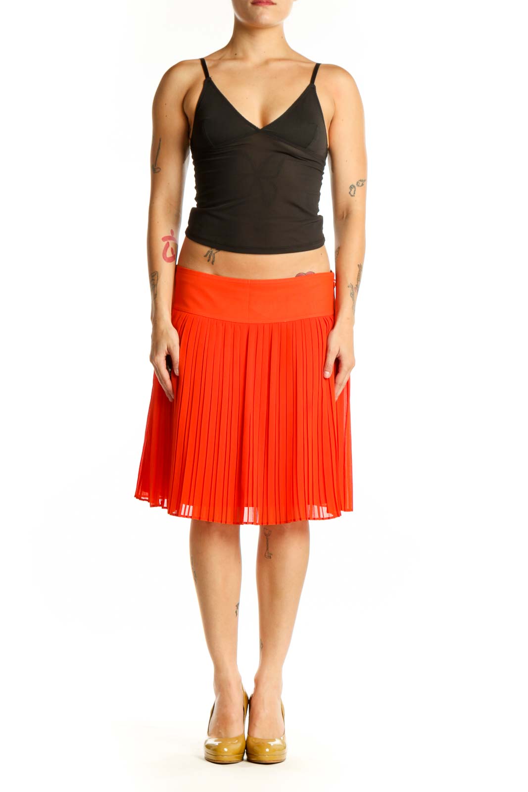 Red pleated A-line knee-length skirt front view on model wearing black top