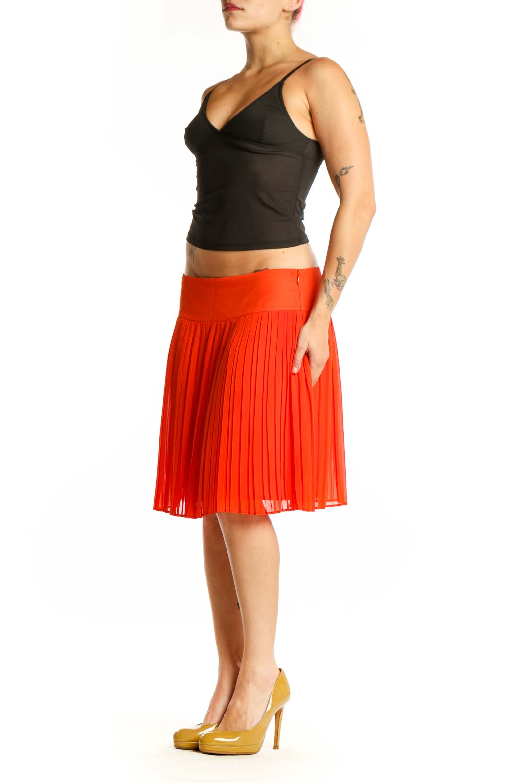 Red pleated A-line knee-length skirt front view on model wearing black top