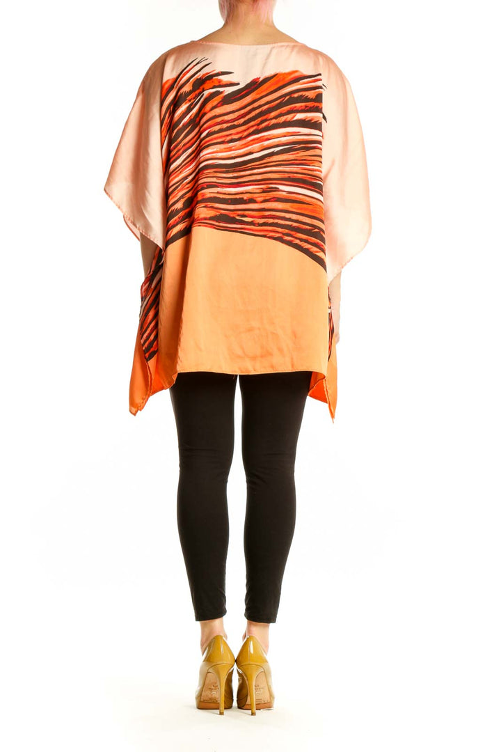 Orange and black striped Dana Buchman caftan top with asymmetrical flowing sleeves, back view on model