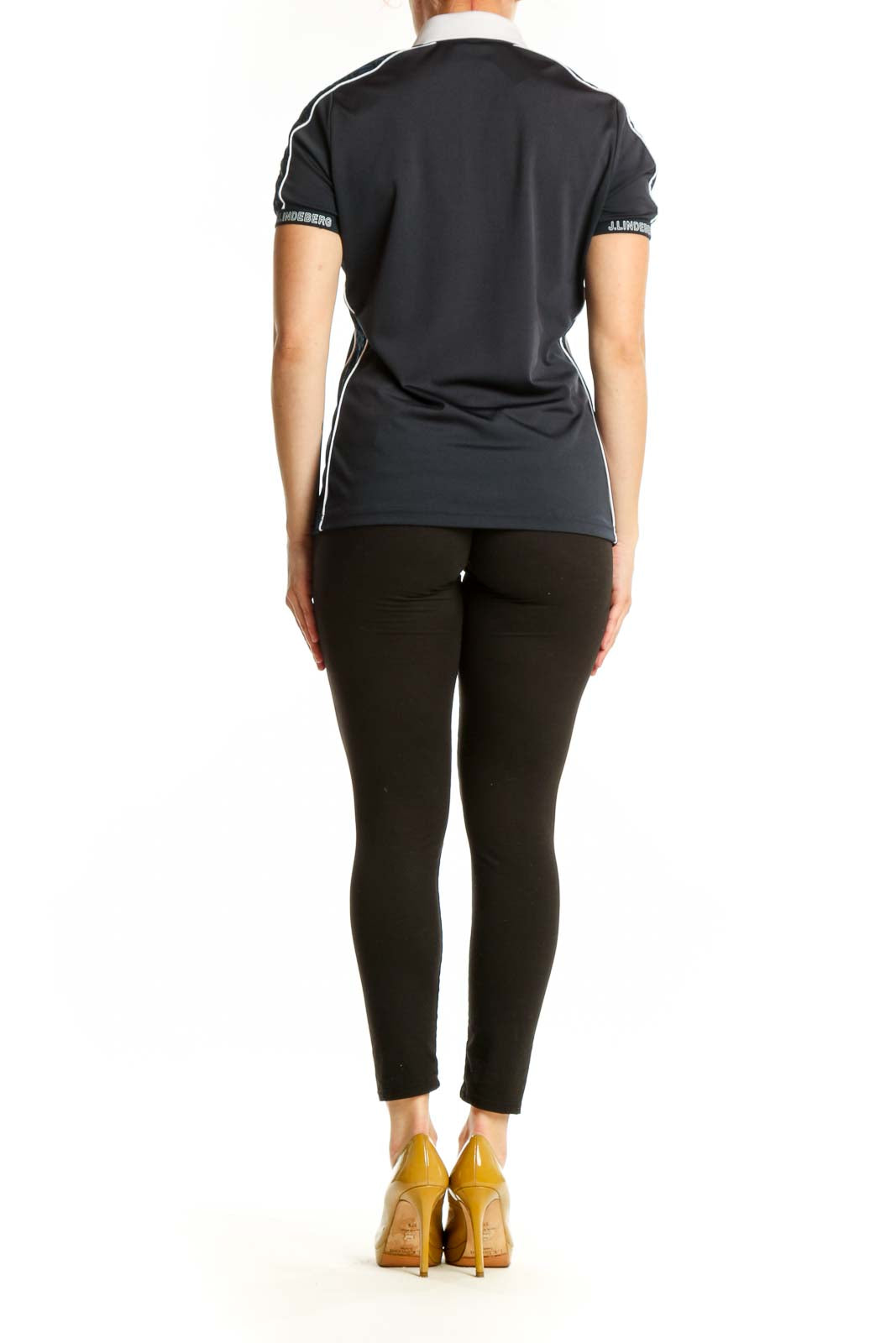 Black polo shirt with white collar and side piping detail, back view