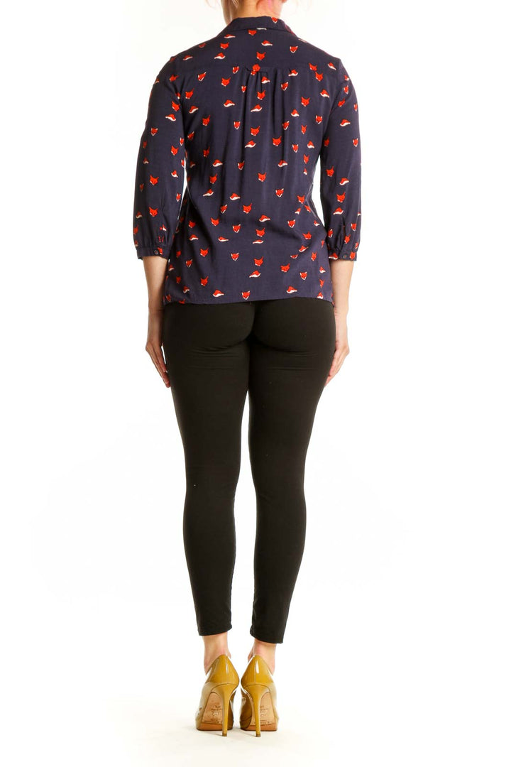 Back view of navy fox print Maeve top showing pleated bust detail and button closure