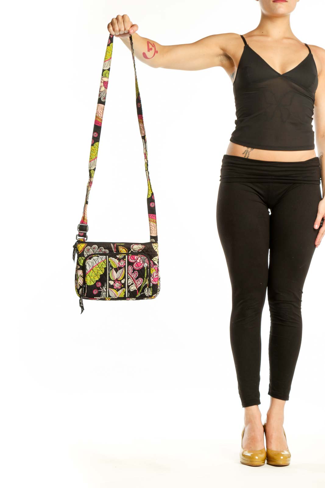 Black floral Vera Bradley crossbody bag with pink, yellow, and green botanical print and adjustable colorful strap