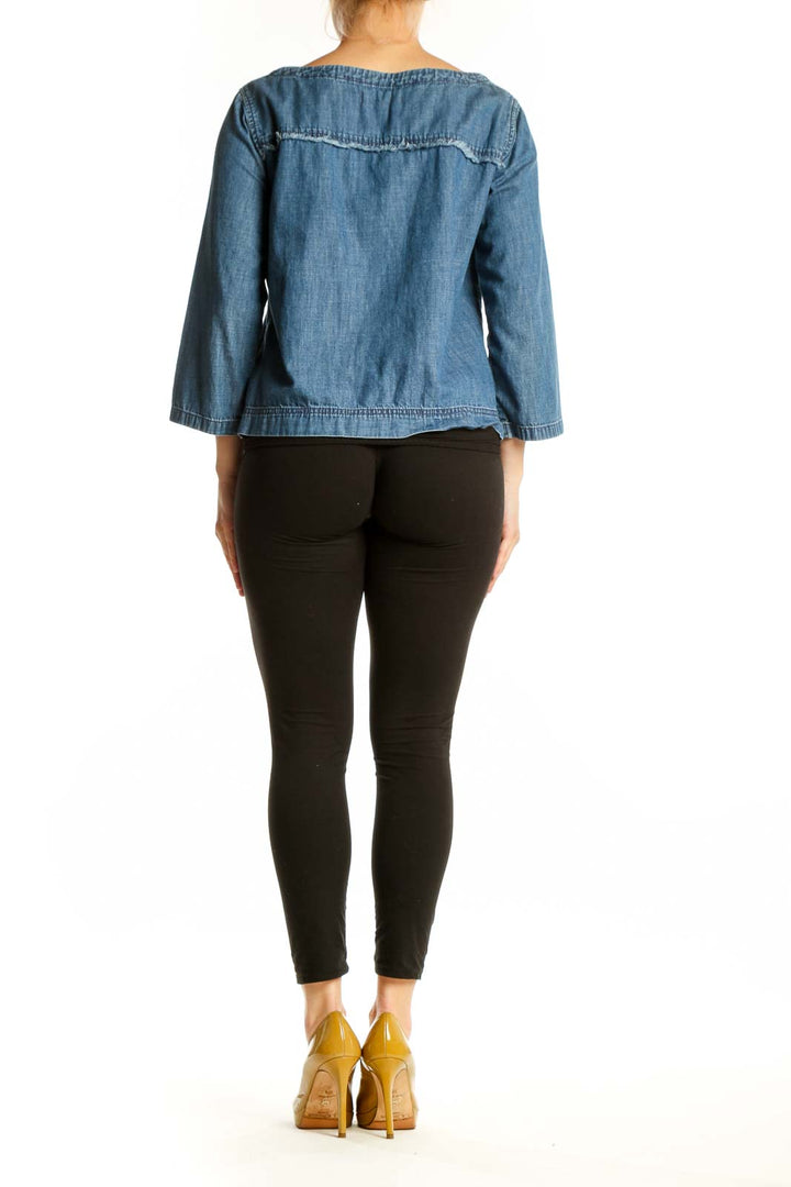 Blue denim cropped top with frayed seam detailing, back view