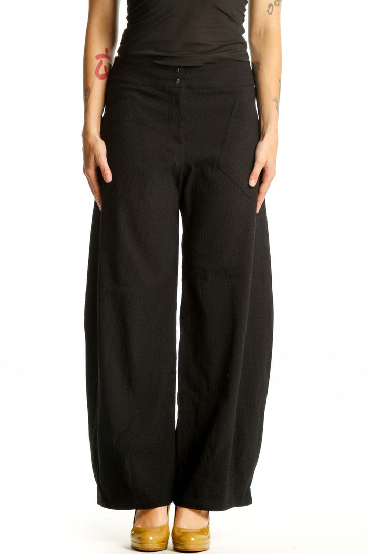Black wide-leg textured pants with high-waisted design, front view on model