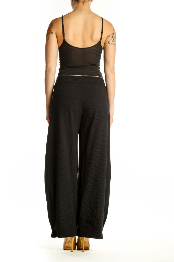 Black wide-leg textured pants with high-waisted design, back view on model