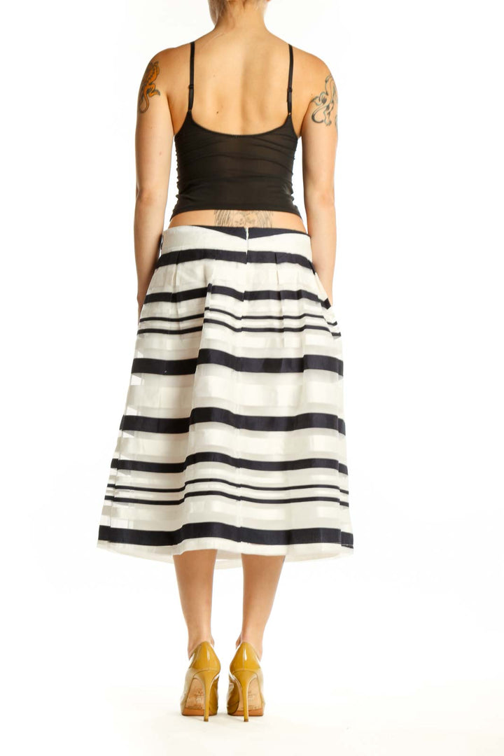 Black and white striped A-line midi skirt back view showing pleated silhouette and elegant drape