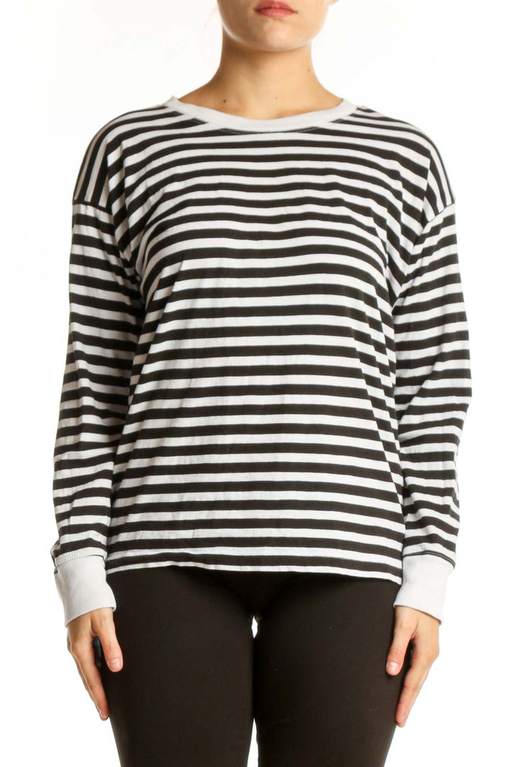 Front view of black and white striped long sleeve cotton top with crew neckline and white ribbed cuffs