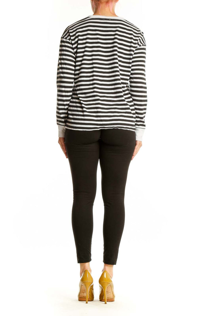 Back view of black and white striped long sleeve cotton top showing relaxed fit and horizontal stripe pattern