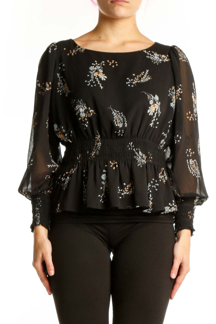 Black floral peplum blouse with sheer sleeves and gathered waist, front view
