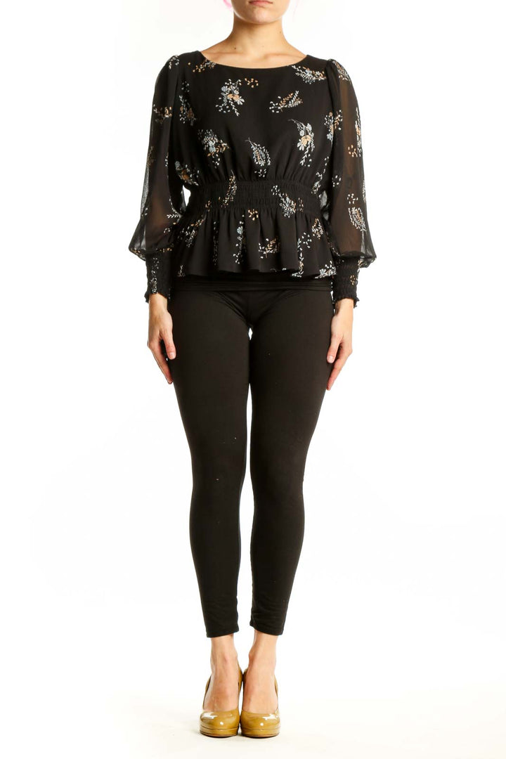Black floral peplum blouse with sheer sleeves and gathered waist, front view