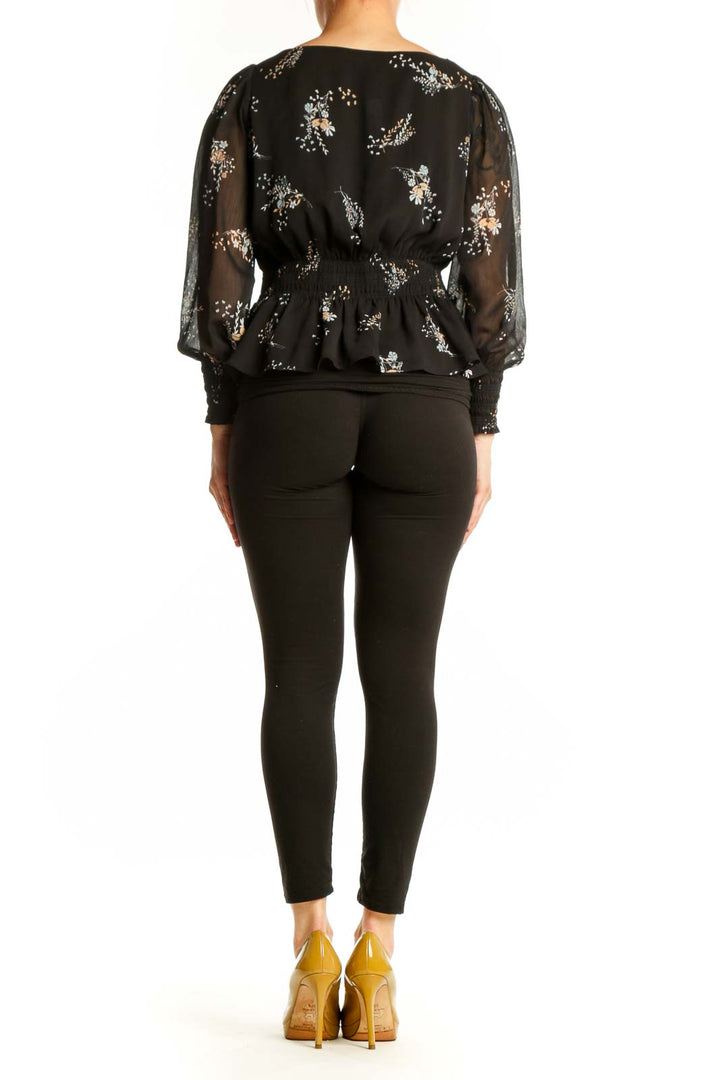 Black floral peplum blouse with sheer sleeves, back view