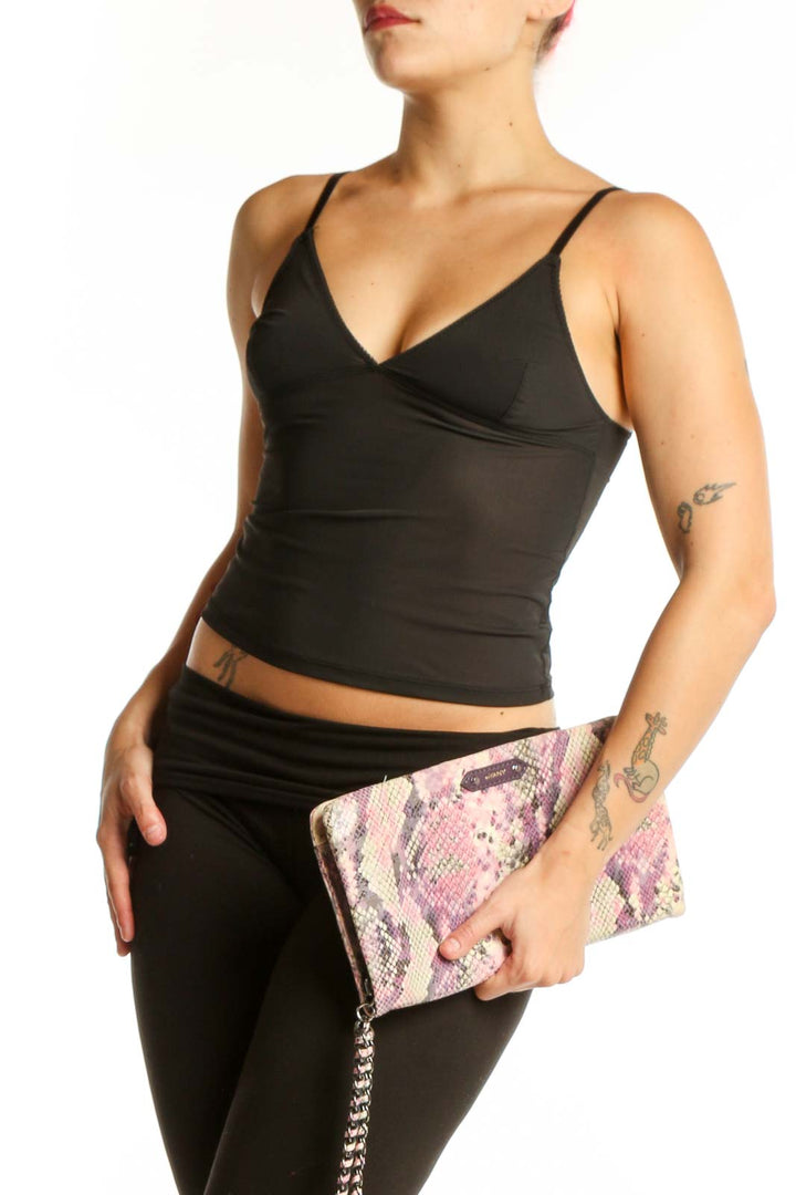 Pink and purple python print orYANY clutch with removable silver chain strap held in hand