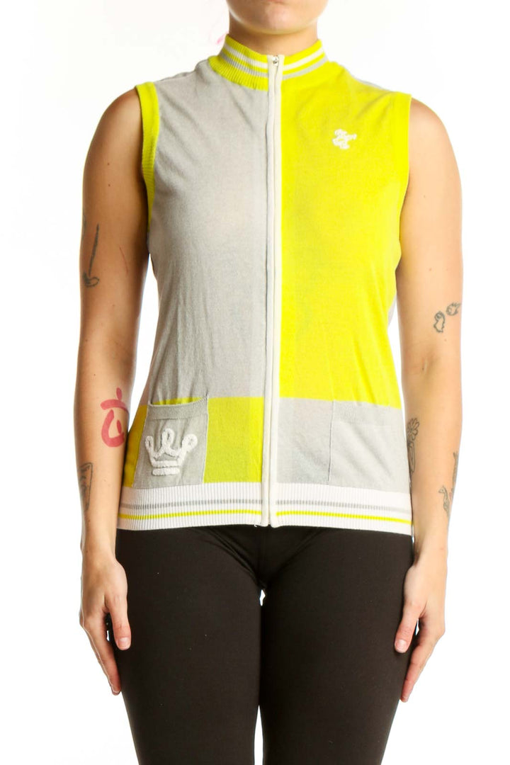 Yellow and cream color-block sleeveless vest with white full-length zipper and ribbed trim, front view