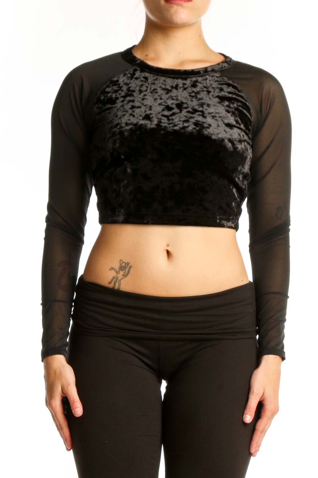 Black velvet crop top with sheer mesh long sleeves by Good American, front view on model