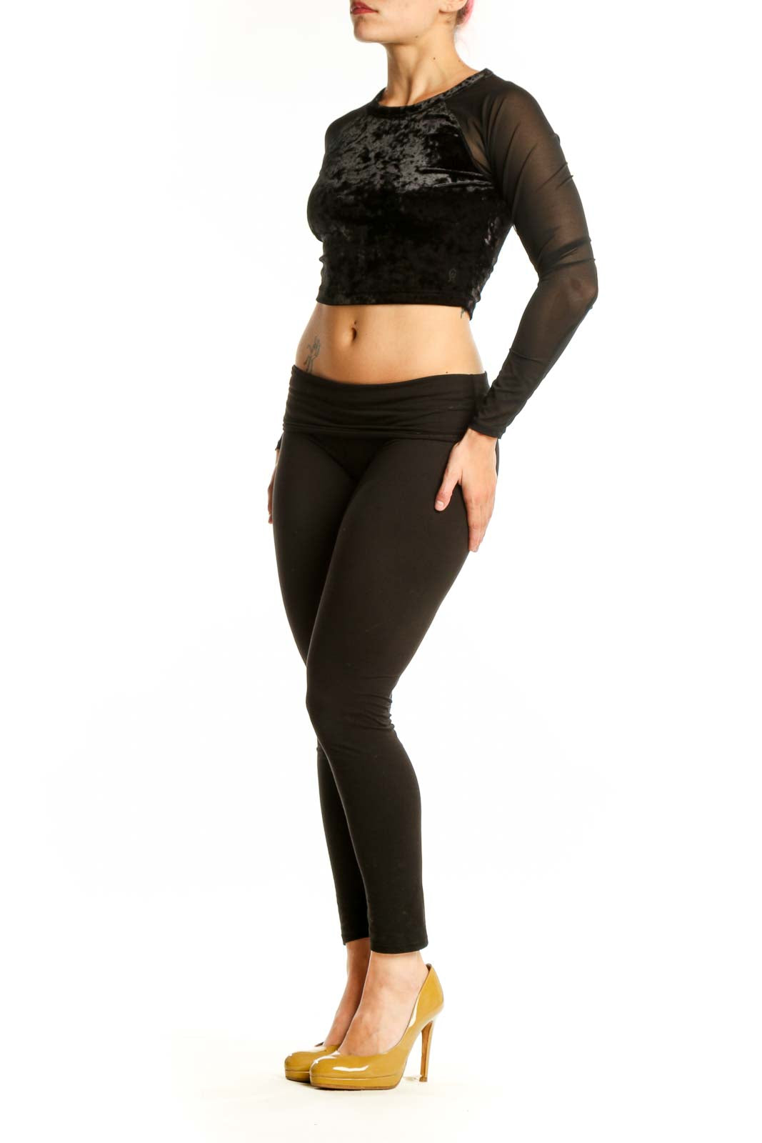 Black velvet crop top with sheer mesh long sleeves by Good American, front view on model