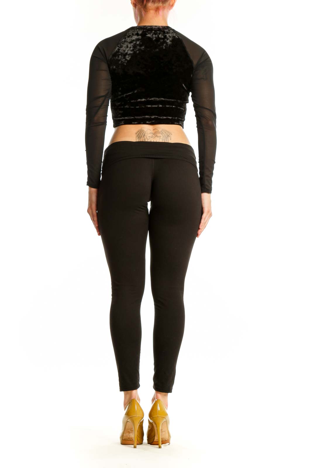 Black velvet crop top with sheer mesh long sleeves by Good American, back view on model