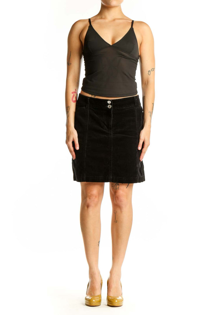 Black velvet mini skirt with dual button detail and straight silhouette, front view