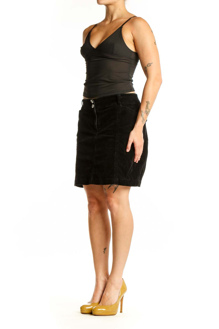 Black velvet mini skirt with dual button detail and straight silhouette, front view