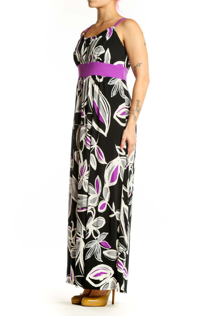 Black floral maxi dress with purple and white botanical print and purple waistband, front view