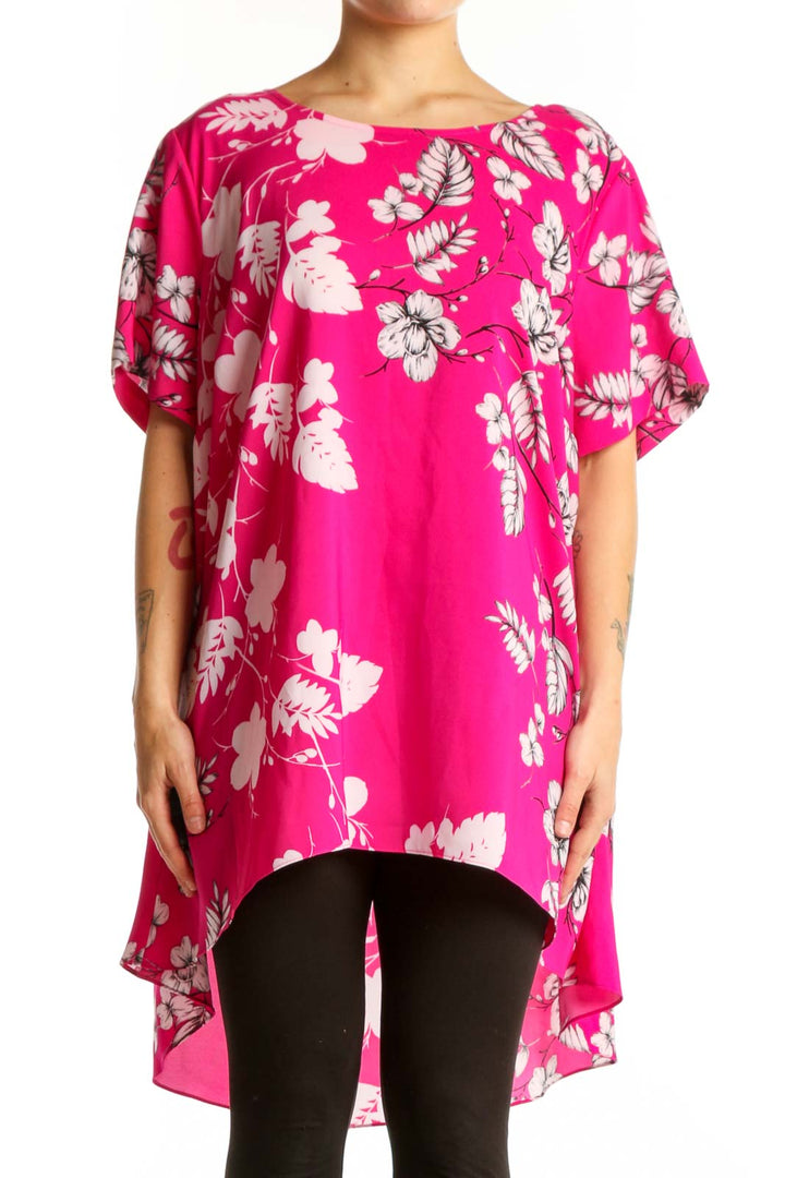 Pink floral hi-low blouse with white and mauve botanical print, short flutter sleeves, worn with black leggings