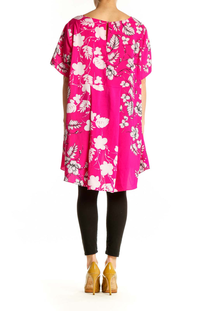 Back view of pink floral hi-low blouse showing flowing hemline and botanical print design