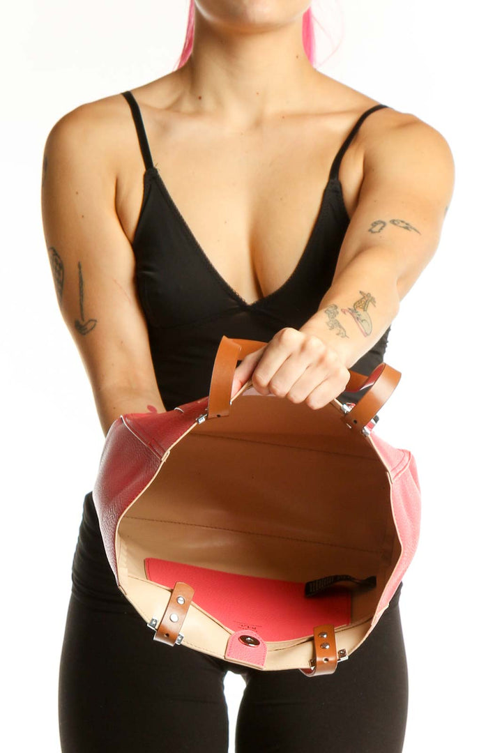 Back view of pink Lauren Ralph Lauren tote bag worn on shoulder, showing structured silhouette and design details