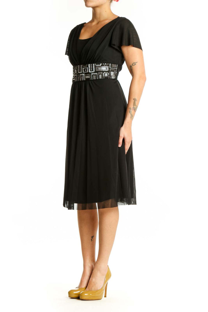 Black embellished empire waist midi dress with geometric beaded belt and flutter sleeves, front view
