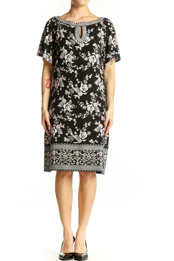 Black floral print short sleeve dress with beaded neckline and keyhole detail, front view