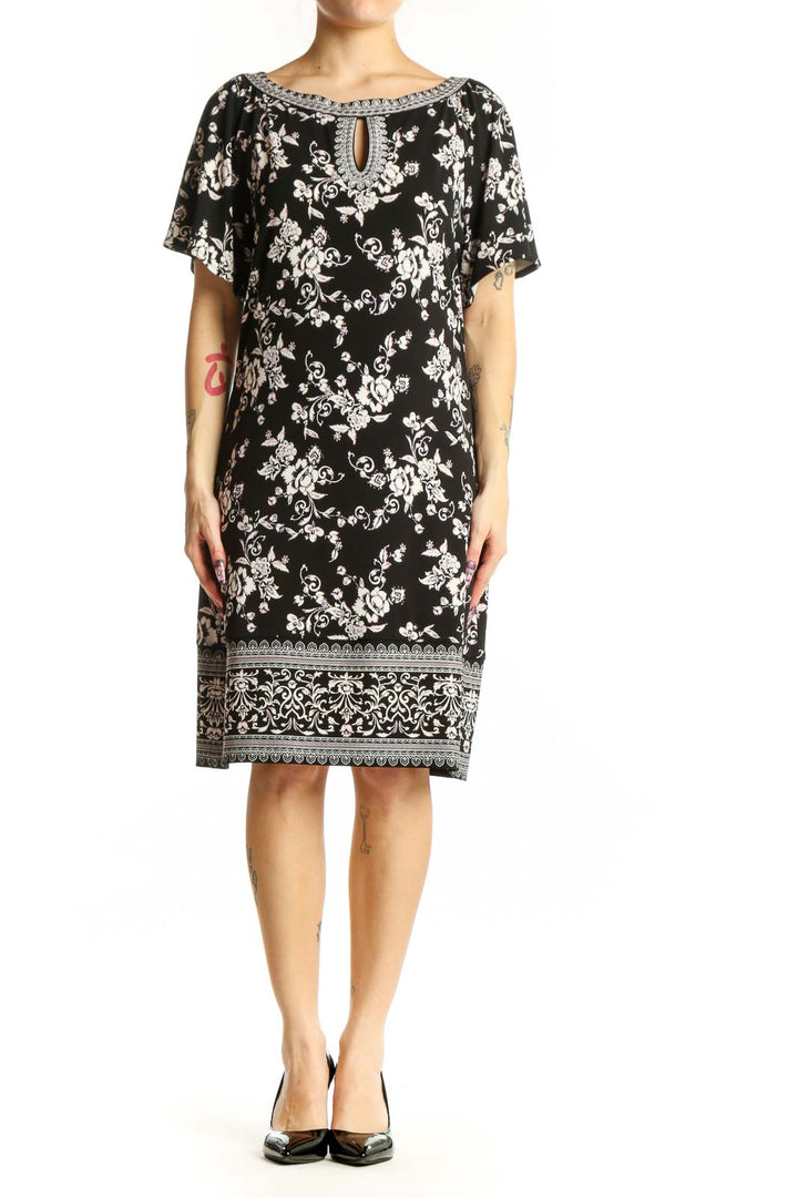 Black floral print short sleeve dress with beaded neckline and keyhole detail, front view