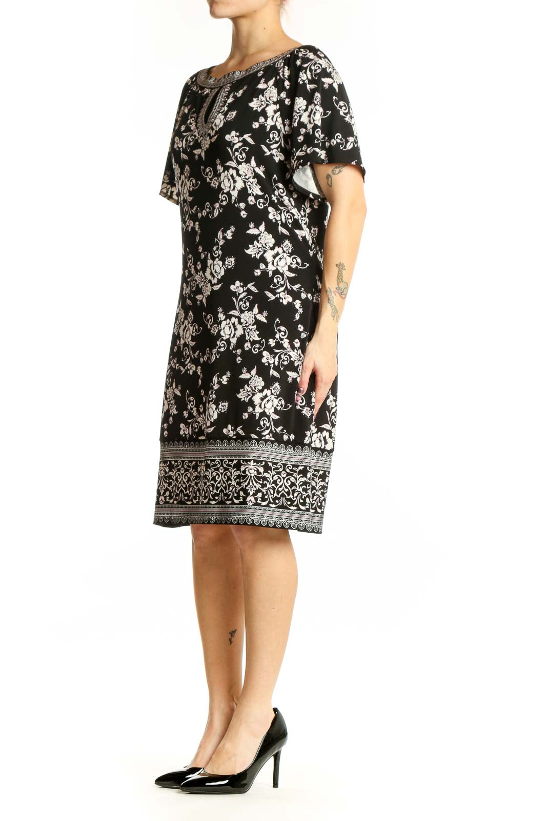 Black floral print short sleeve dress with beaded neckline and keyhole detail, front view