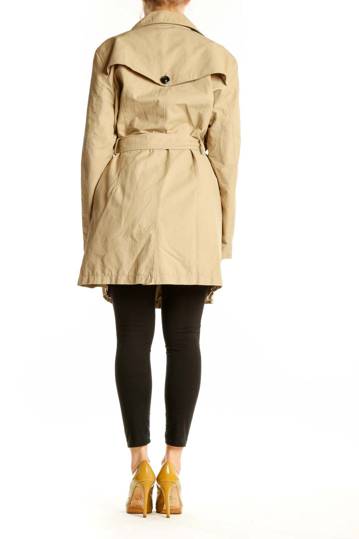 Beige trench coat with tied belt detail, back view showing knee-length cut