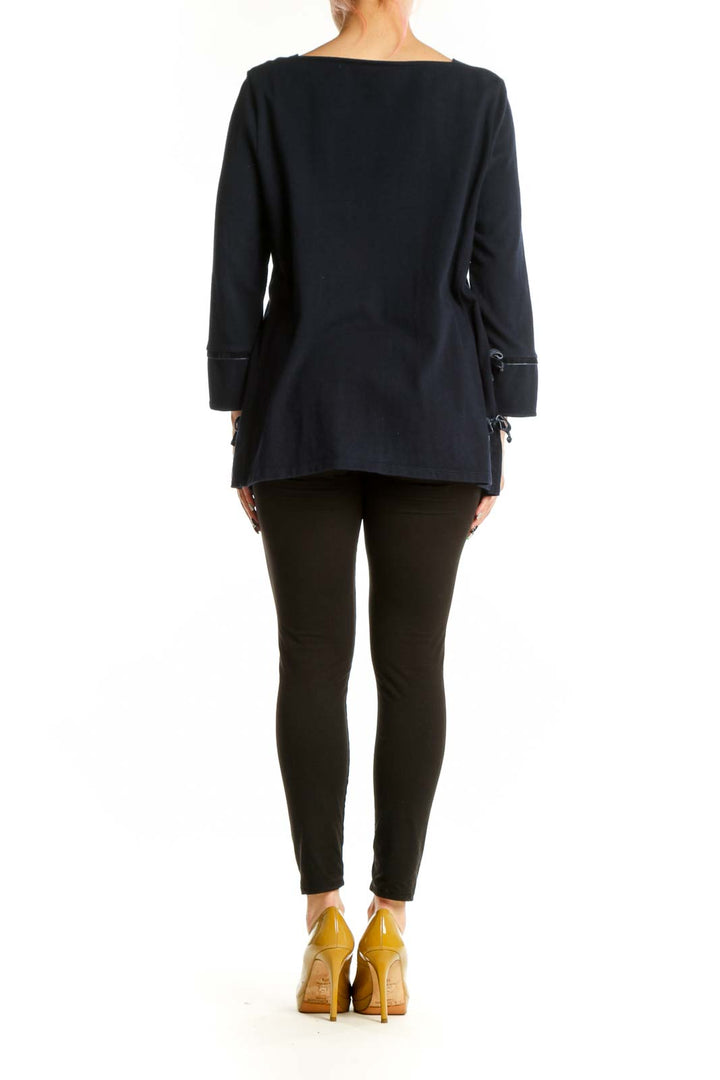 Navy cotton long sleeve top with rolled cuff details, back view on model