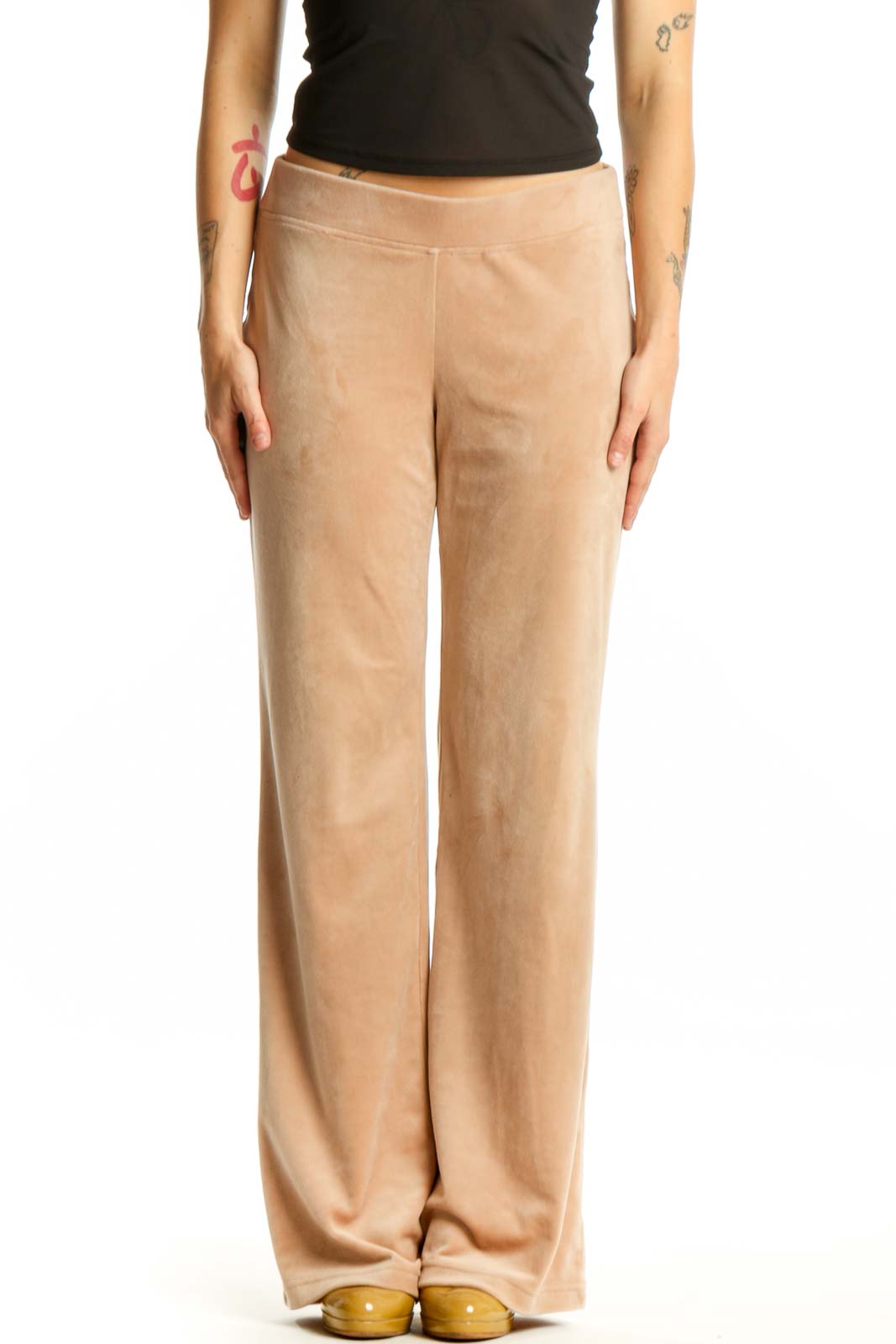 Beige velour activewear pants with elastic waistband, front view on model
