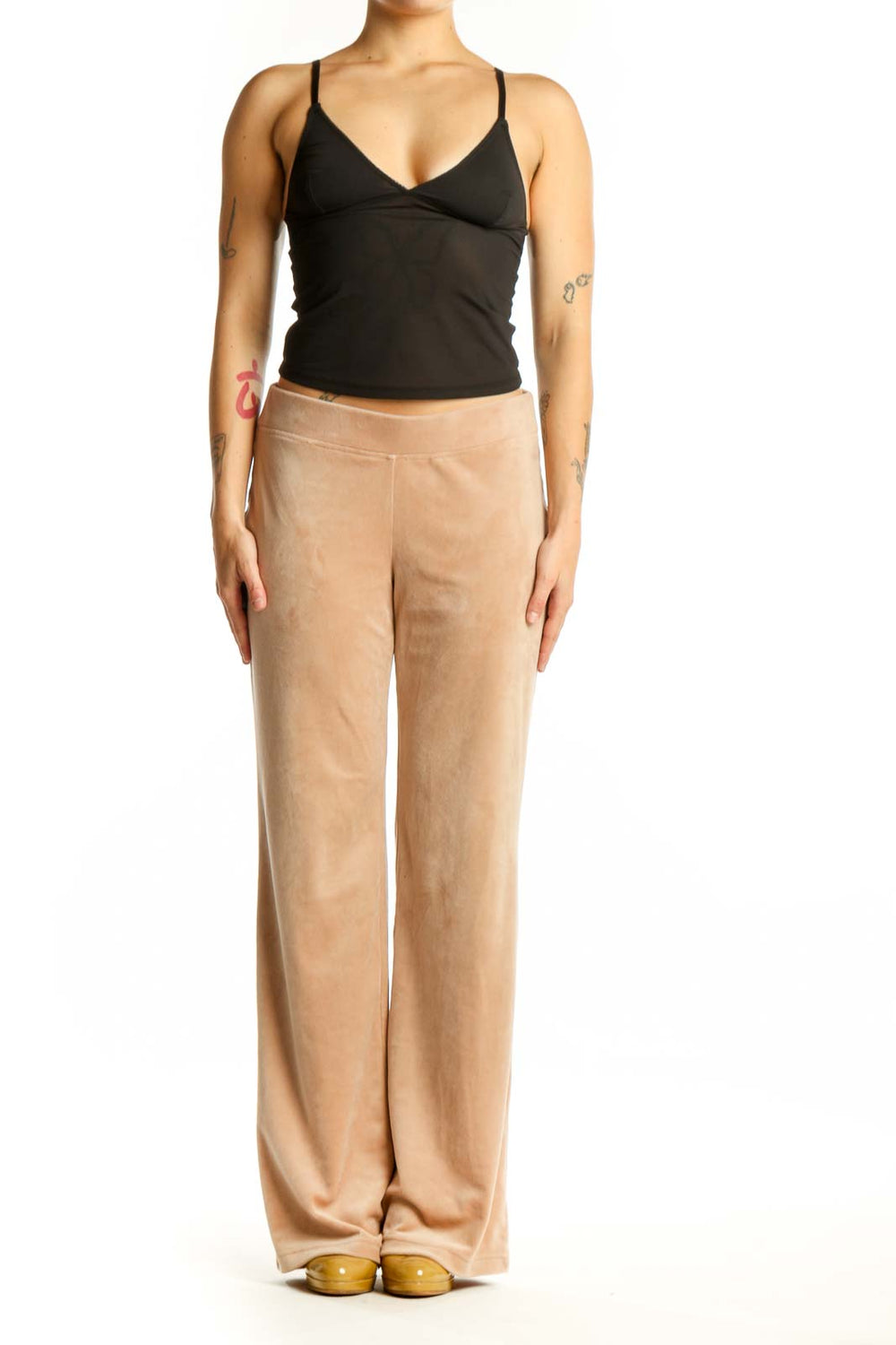 Beige velour activewear pants with elastic waistband, front view on model