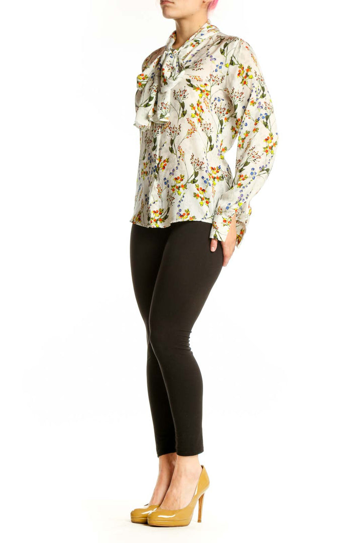 Cream floral button-up blouse with vibrant botanical print, long sleeves, and collared neckline