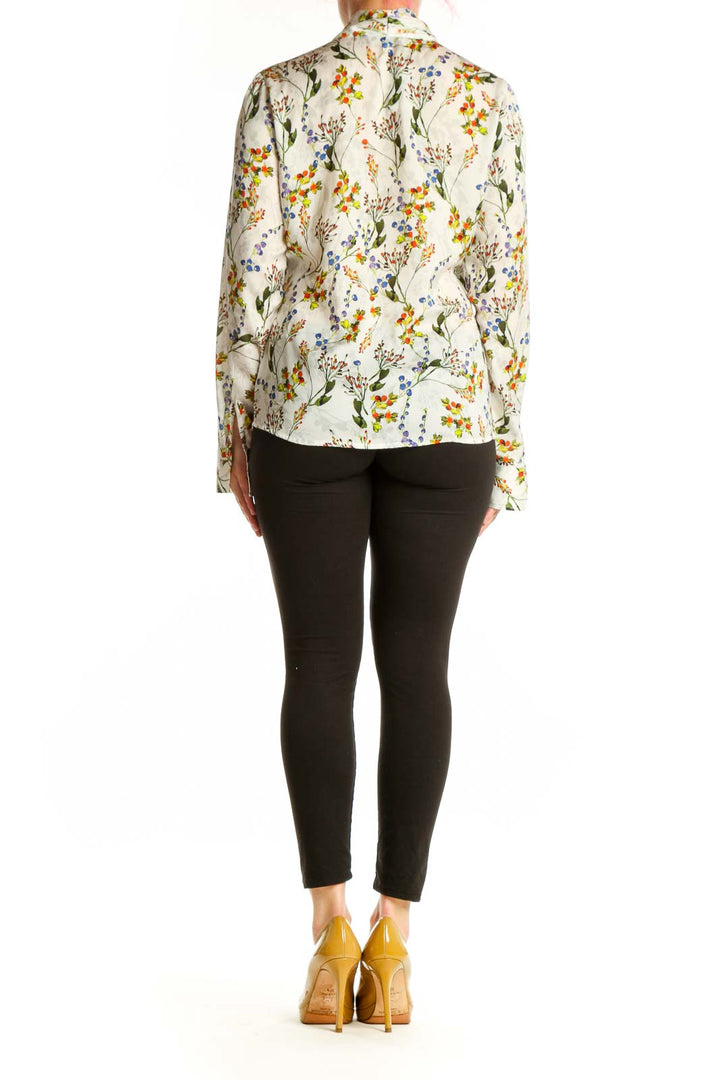 Back view of cream floral blouse showing full botanical print pattern and tailored fit