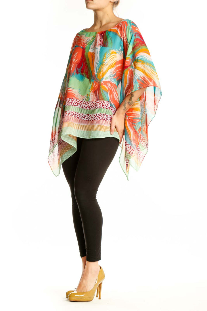 Multicolor abstract print poncho top with flowing asymmetrical hemline, featuring vibrant red, orange, green, blue and yellow brushstroke patterns