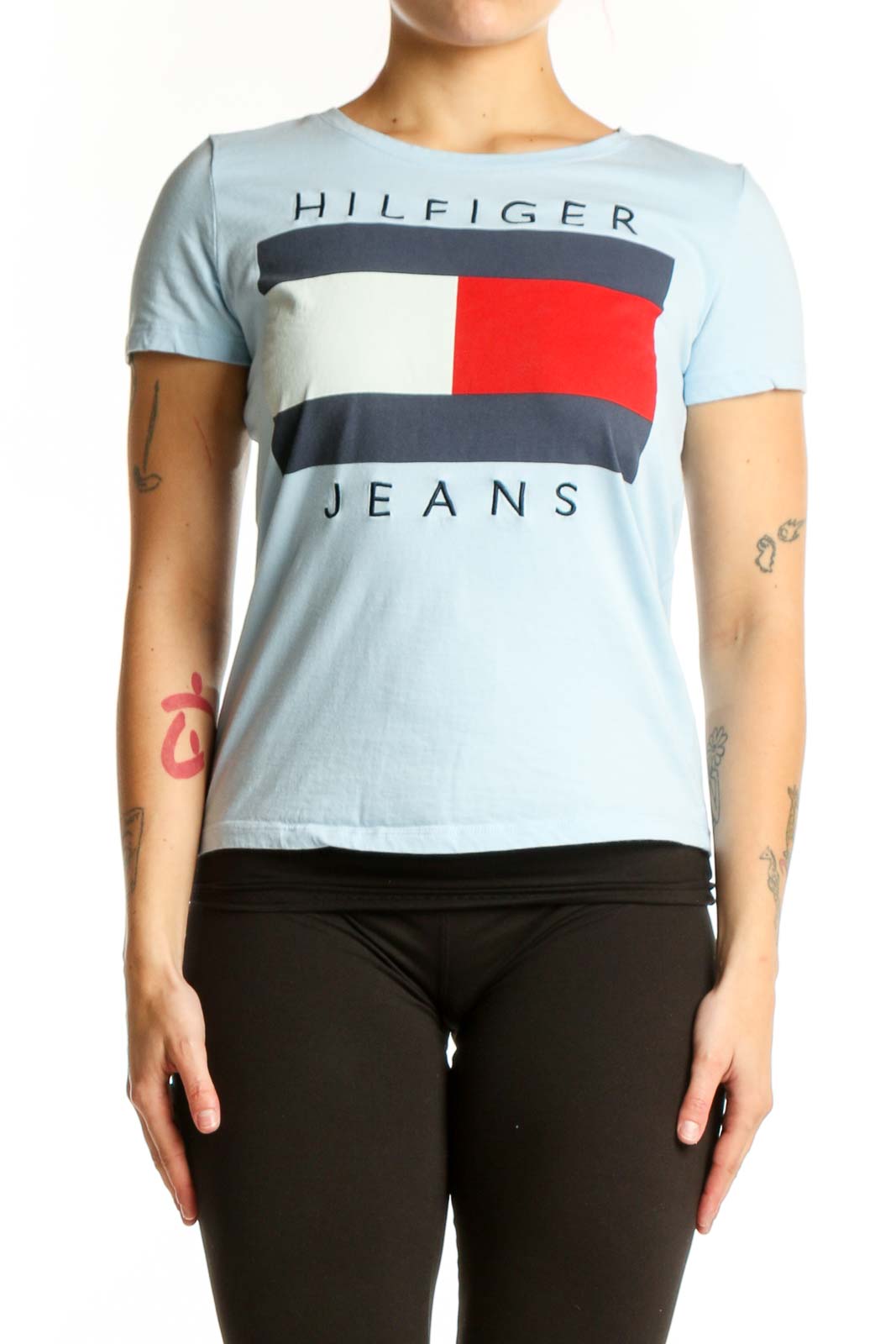 Light blue Hilfiger Jeans graphic t-shirt with colorblock logo design featuring red, navy, and cream stripes