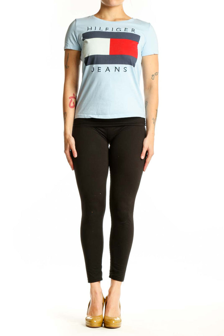 Light blue Hilfiger Jeans graphic t-shirt with colorblock logo design featuring red, navy, and cream stripes