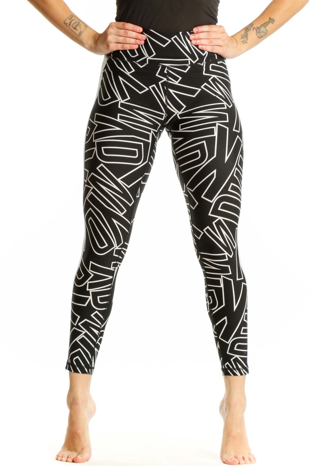 Black and white geometric print DKNY Sport leggings front view, high-waisted fit with abstract line pattern