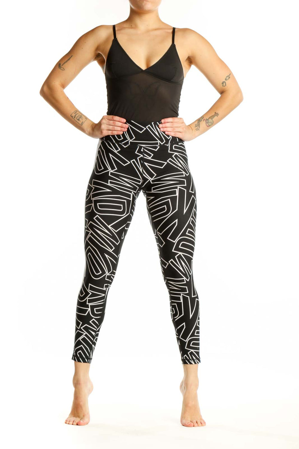 Black and white geometric print DKNY Sport leggings front view, high-waisted fit with abstract line pattern